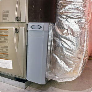 Ductless mini-split condenser mounted on a home&rsquo;s exterior siding.